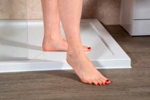 Image showing the feet of a person stepping out of a low level shower tray.