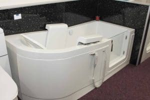 Venezia (Easy Riser Full Length Access Walk-in Baths). Accessible bath with mobility aid on display at Life Quality Bathing showroom near Tamworth, Staffordshire, designed to support individuals with limited mobility and enhance bathing independence.
