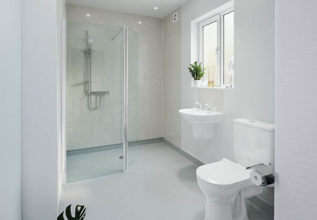 Plain white and simplistic deigned wet room, glass screen covering the side which the shower is mounted on the wall.
