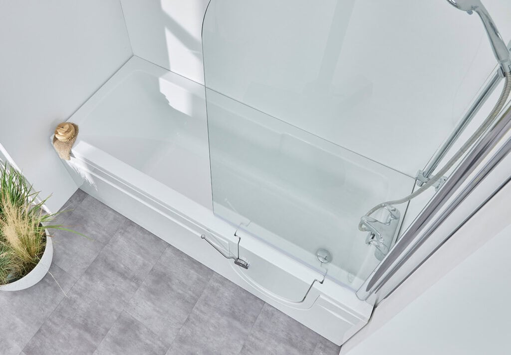 Livorno (Arizona) walk-in shower bath. Aerial view. Long metal leaver to open side door. Natural light coming in from right.