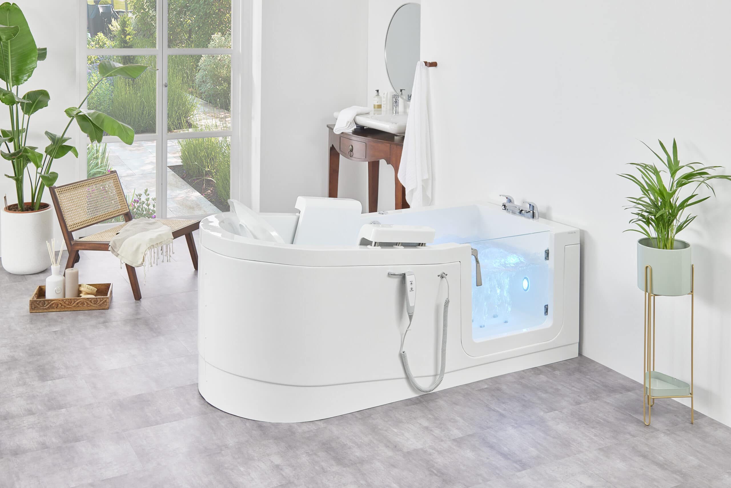 The Venezia (Easy Riser) walk-in bath features a sleek, speedboat-inspired design and an electronically controlled seat filled with water to almost the very top. Situated as a T shape against the wall